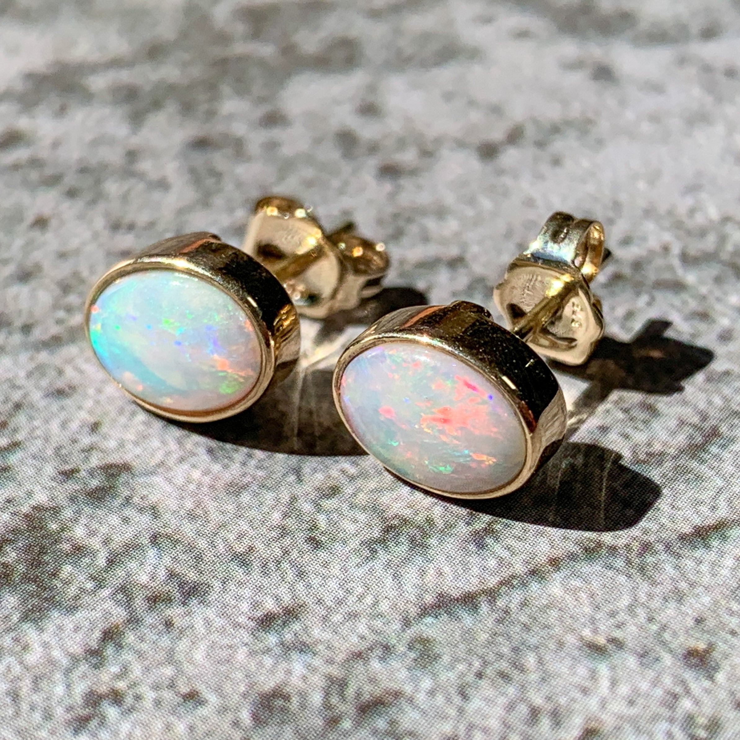 One pair of 9kt Yellow Gold Light Opal earring studs 7x5mm bezel set - Masterpiece Jewellery Opal & Gems Sydney Australia | Online Shop